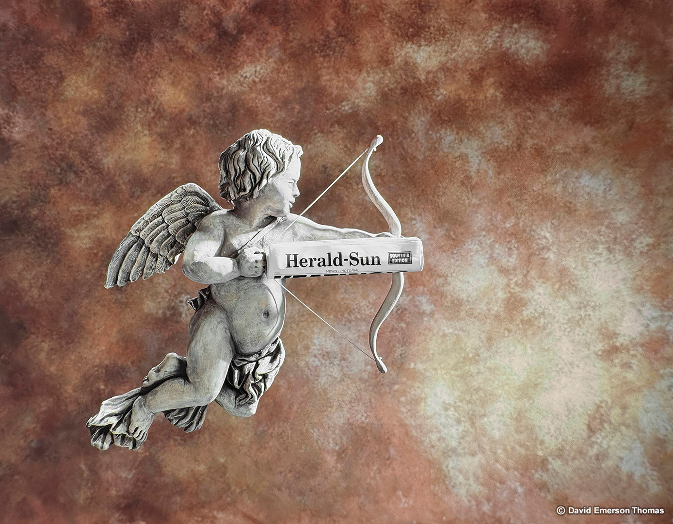 Sculpture of Cupid + Backdrop for the Cover Page of the Herald Sun Newspaper, Valentine’s Day Edition clay sculpture & plaster cast (aged for a weathered look) + painted texture backdrop by Australian artist David E Thomas, 1999. Heaven Pictures Studio - South Yarra, Victoria, Australia
